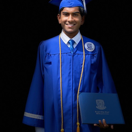 Rohan Shirur wearing a blue graduation gown and mortarboard